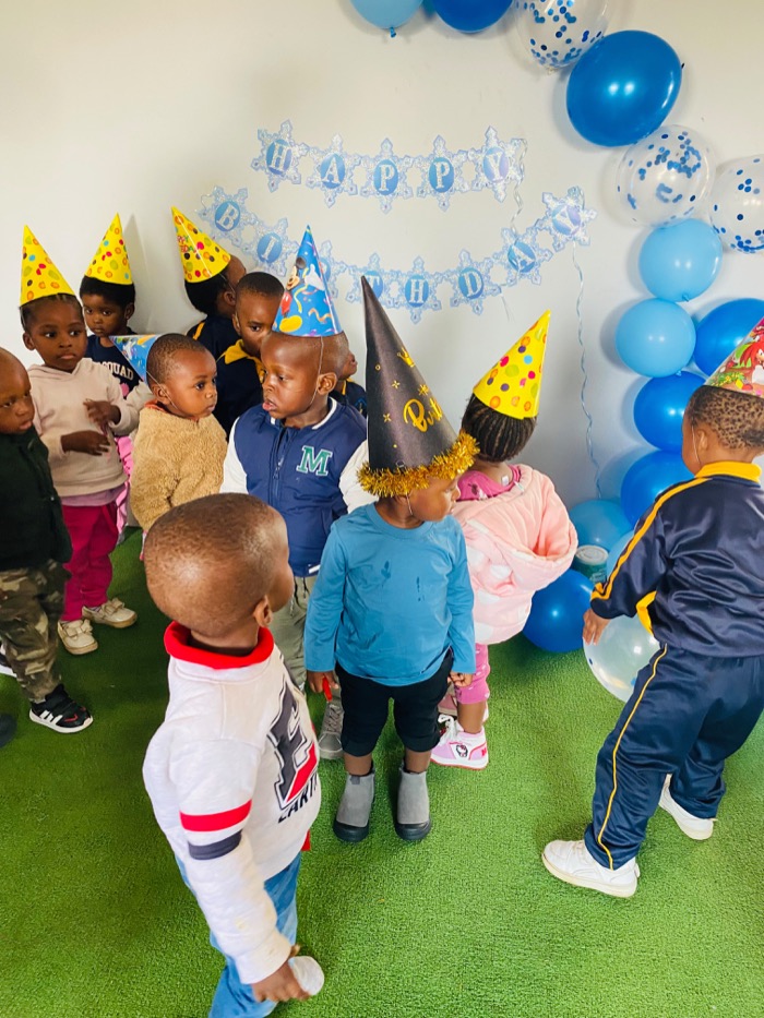 A birthday celebration with party hats and balloons