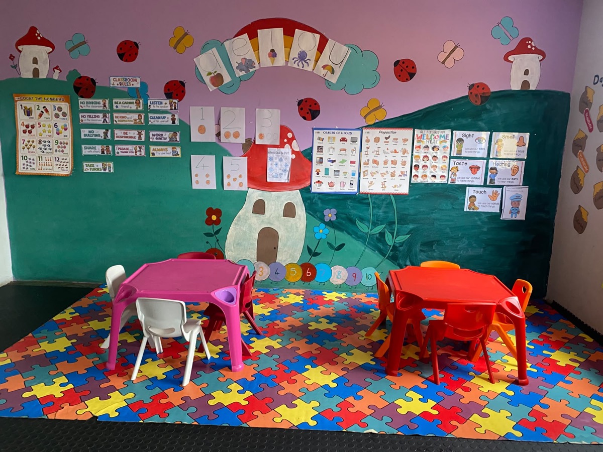 The Cuddle Cubs corner with its mushroom-house mural and soft puzzle mat